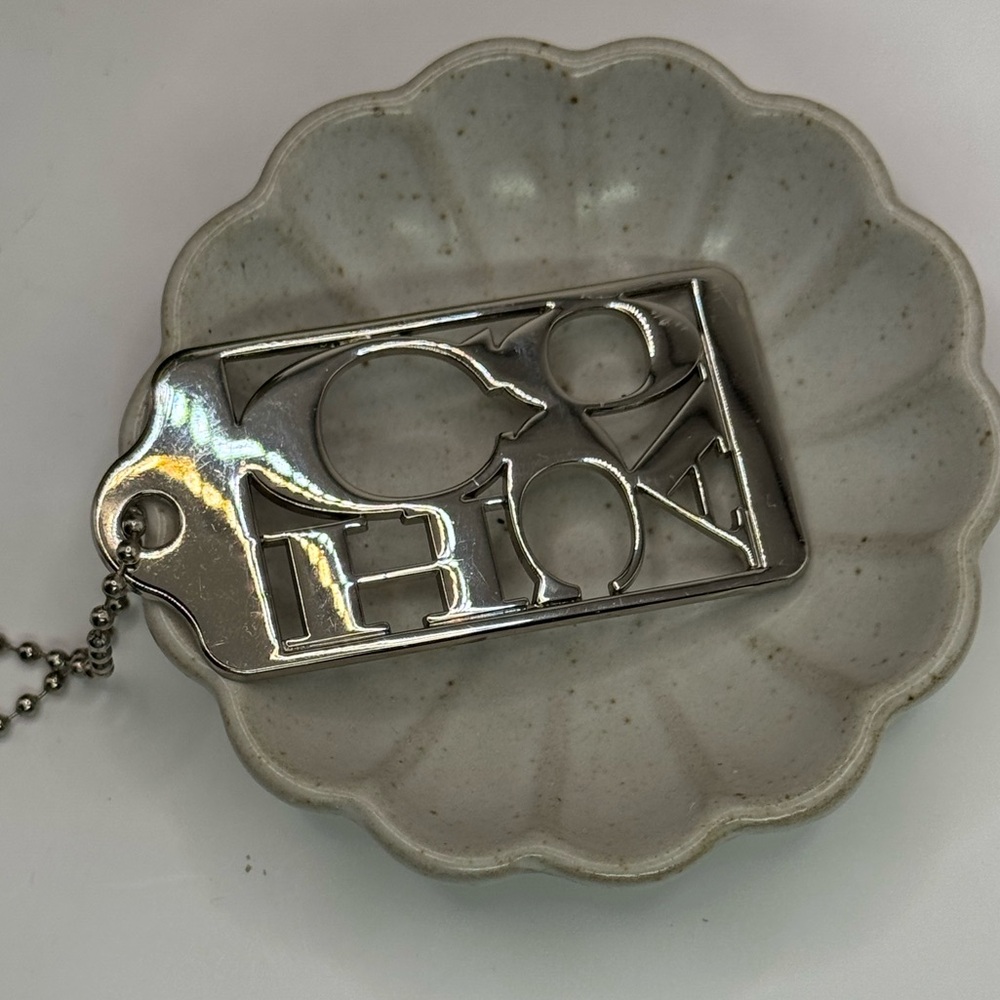 Coach metal script signature tag silver